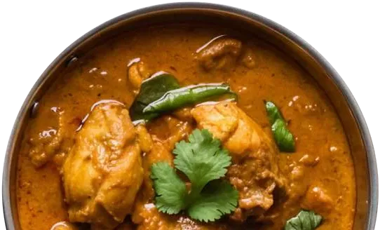 Chicken curry topped with coriander in a copper balti dish