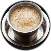 Frothy filter coffee in a steel tumbler and saucer