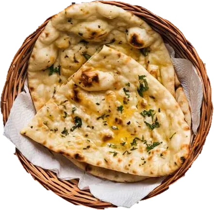 Buttery naan flecked with herbs in a paper-lined wicker basket