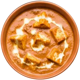 Paneer cubes in orange tomato gravy with a swirl of cream, in a terracotta pot