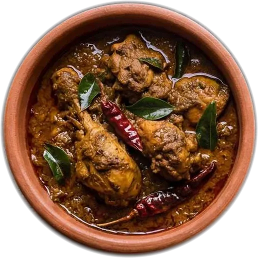 Dark dry-roasted chicken with curry leaves and dried red chillies in a terracotta pot